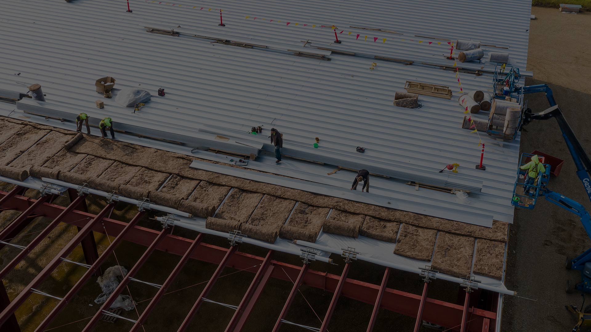 aerial view of contractors installing metal roofing at commercial building kansas city mo